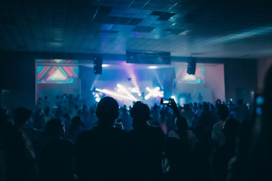 Festivais de Música Brasil — Vibrant indoor concert scene with a crowd enjoying live performances under dynamic stage